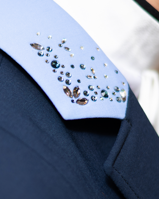 Detail of Swarovski embellishment on the collar of JuulC Women's competition jacket in Navy Light Blue